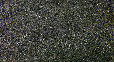 Black sand closeup background texture