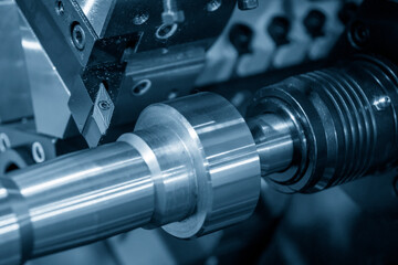 The  CNC lathe machine finish cutting the metal shaft parts. The hi-technology metal working...