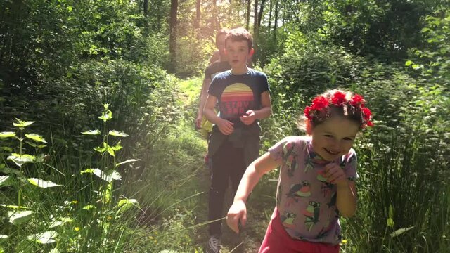 Young Family Finding Freedom In A Summer Woodland Walk