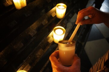 Lighting a memorial candle at church