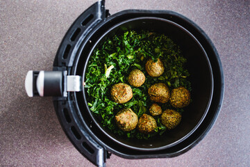 plant-based food, falafels and kale chips in air fryer