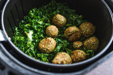 plant-based food, falafels and kale chips in air fryer