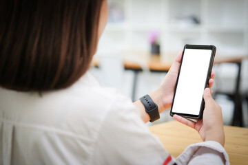 Mock up smartphone of hand holding black mobile phone with blank white screen.