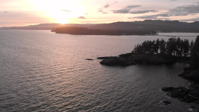 Aerial sunset drone footage of the rugged coastline of the east side of Vancouver Island.