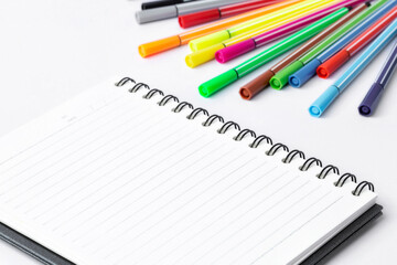 Notebook and Color pen on white background