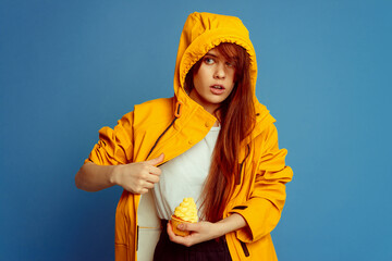 girl with yellow cupcake in yellow raincoat