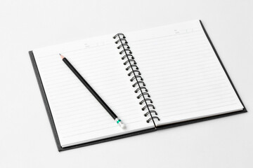 Notebook and pencil on white background