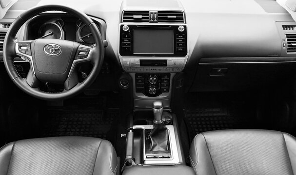 BIYSK, RUSSIA - MAY 16, 2020: Luxury car interior Toyota Land Cruiser Prado-with dashboard, clock, media system, front seats and shift gear.. Black and white photography.
