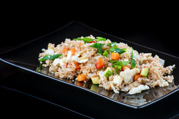 A plate of food with rice and vegetables