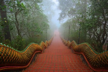 Great naga ladder. At Wat Phra That Doi Suthep temple in Chiang Mai, Thailand. foggy rainy day. Age...