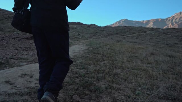 Following shot of a  man walking down the mountain at chandratal lake , spiti valley