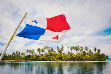 Panamanian Flag waving on a wooden pole with Paradise Island in background - Guna Yala Islands San...