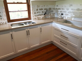 Total renovation of a kitchen with new cupboards, tiles, bench top and appliances