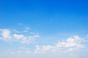 Blue sky background and white clouds soft focus, and copy space