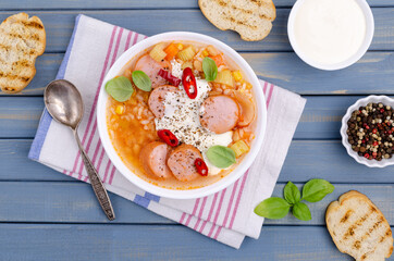 Soup with rice and beans, sausages and vegetables