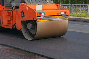 Urban road construction, paver. Road roller for laying new asphalt.