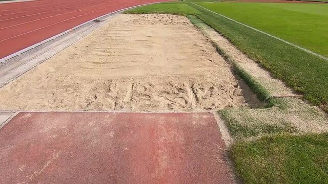 Long jump athlete field of view. Track and field sport event.