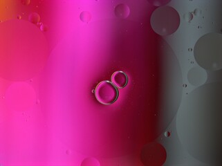 Beautiful bubbles oil with colorful red pink background ,dropslets macro image ,abstract background, sweet pastel color for card design