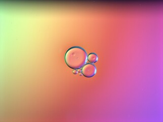 Beautiful bubbles oil with colorful yellow pink background ,dropslets macro image ,abstract background, sweet pastel color for card design