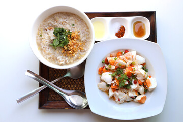 Closeup Rice porridge machine Served in a white bowl Complete with salted eggs and seasonings, chili powder, sugar, fish sauce, lime.