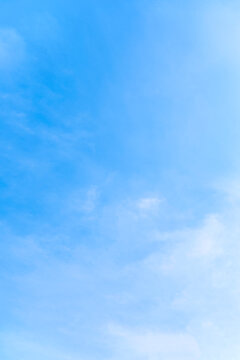 Vertical of tranquil blue sky with smooth cloud