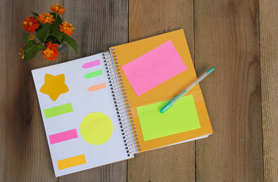 Notebook on Desk With Sticky Notes 