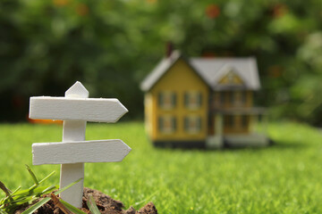 Rustic Signboard in Rural  Outdoor Area, Blurred Farmhouse in background 