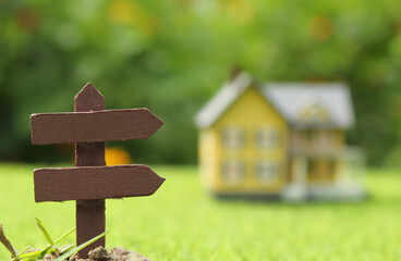 Signpost With Blurred Farmhouse in Background
