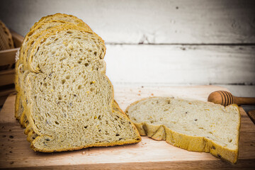 Fresh whole wheat bread, cut into pieces, set on a wooden floor table