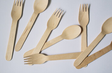 Flat-lay concept of bamboo forks and spoons on a white background, plastic-free concept,...