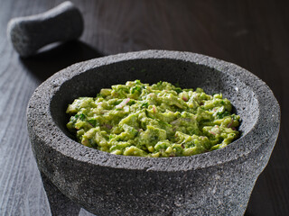 fresh guacamole in stone molajete