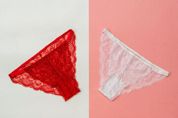 Red and white women's panties on a white and red background. Underwear. The view from the top.