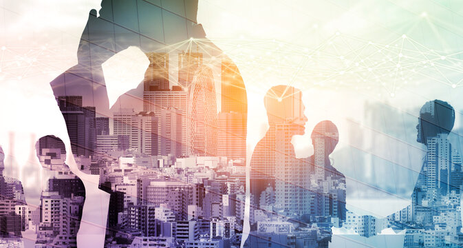 Creative image of many business people conference group meeting on city office building background showing partnership success of business deal. Concept of teamwork, trust and agreement.