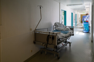 there's an empty patient bed in a surgical hallway