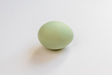 Multicolored village chicken eggs on a white background