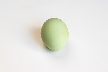 Multicolored village chicken eggs on a white background