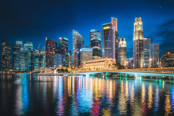 Fototapeta na wymiar Business Financial Downtown City and Skyscrapers Tower Building at Marina Bay, Singapore, Cityscape Urban Landmark and Business Finance District Center in Twilight Scene, Capital City of Singapore.