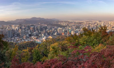 Foto op Canvas Panoramic view of the city Seoul in autumn, taken from N Seoul Tower. City skyline, skyscrapers and hills. Red and green trees in the forest surrounding the city. Aerial view. Seoul, South Korea, Asia © Alba