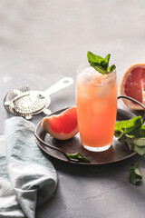 Fresh grapefruits and glass of grapefruit juice