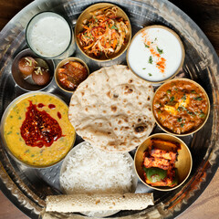 Indian Thali with Rice, Curry, Gravy, Bread, Pickles and Sweet Dish