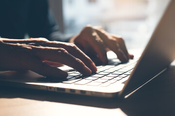 Closeup of man hand typing and working on laptop computer