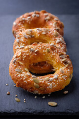 Cottage cheese rings or donuts with seeds on dark background