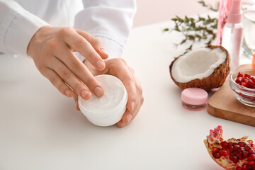 Beautician with jar of natural cream, closeup