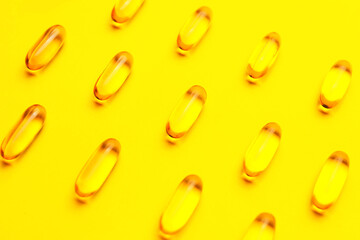 Fish oil capsules on color background