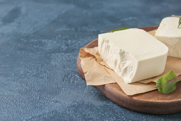 Tasty feta cheese on dark background