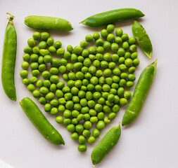 Green fresh peas isolated on white top view.