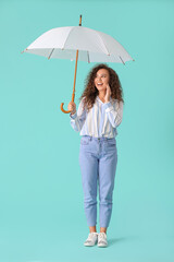 Beautiful young woman with umbrella on color background