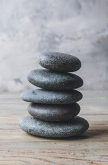 Stack of spa stones on grey background