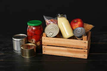 Donation box with products on dark background