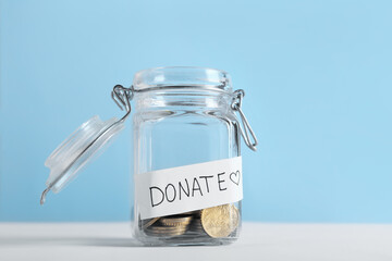 Glass jar with coins on table. Concept of donations